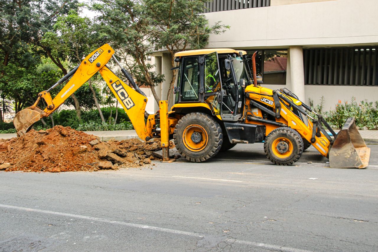 Street view of an excavator in Sandton, highlighting urban development and construction activities.